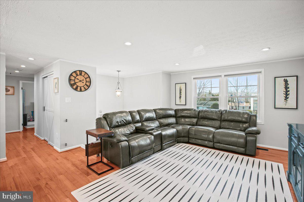 5829 Parakeet Drive Burke, VA 22015 - Photo 4 of 27 a living room with furniture and a wooden floor