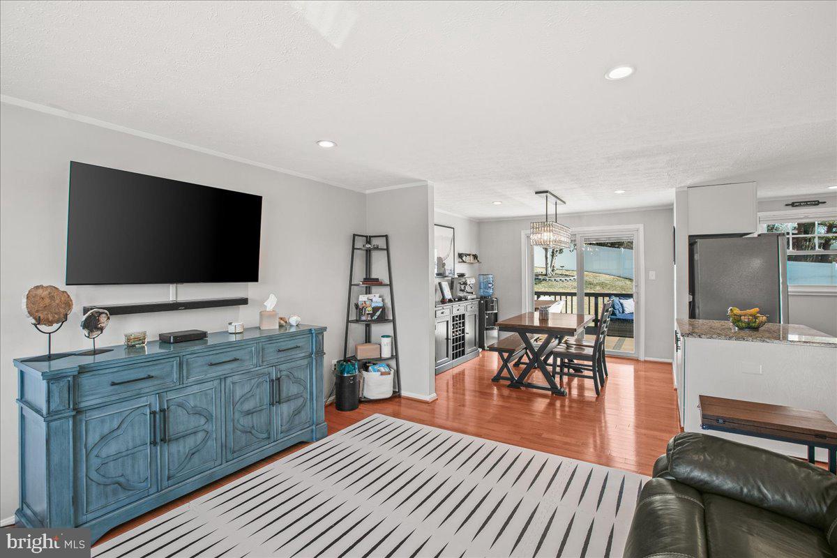 5829 Parakeet Drive Burke, VA 22015 - Photo 6 of 27 a living room with furniture and a flat screen tv