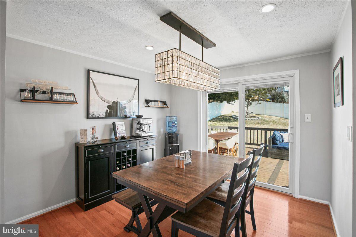 5829 Parakeet Drive Burke, VA 22015 - Photo 7 of 27 a view of a dining room with furniture window and wooden floor
