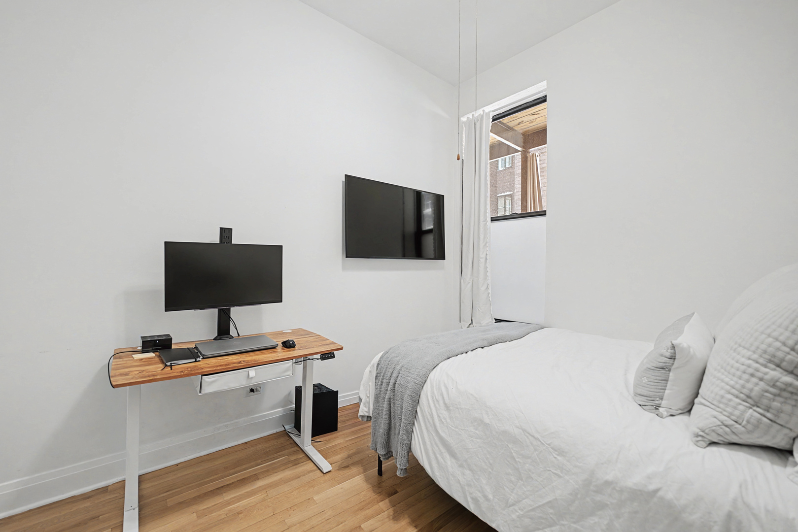 832 West Adams Street, Unit 2 Chicago, IL 60607 - Photo 15 of 23 a bedroom with a bed and a flat screen tv