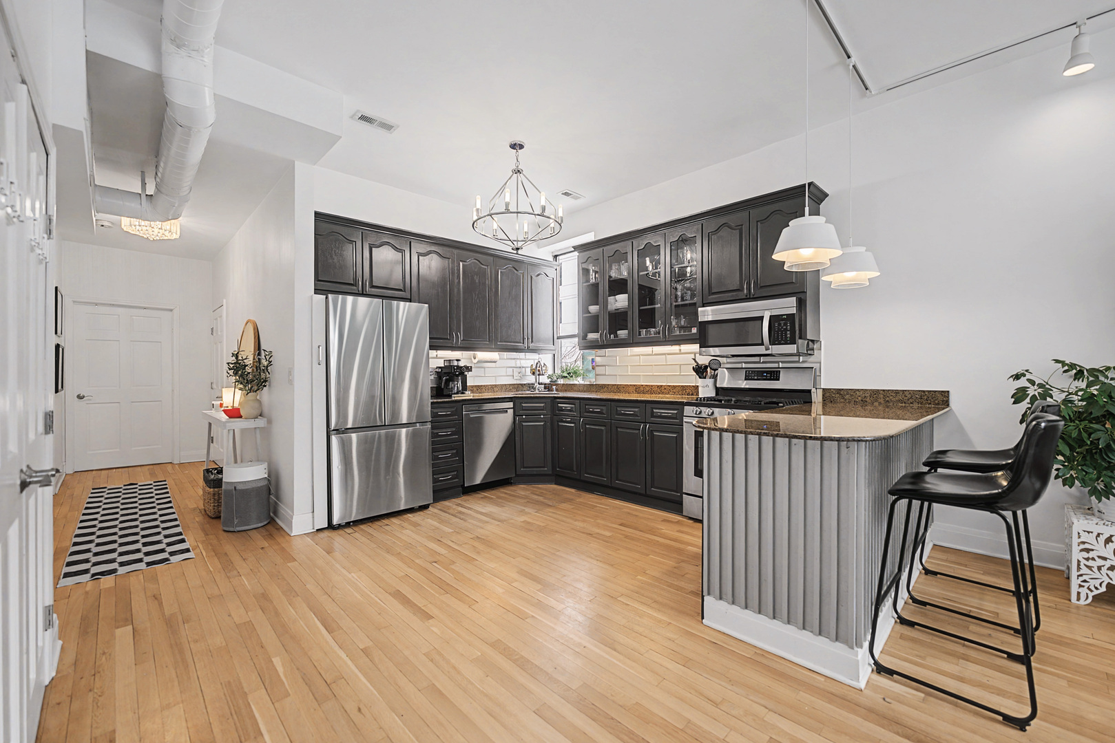 832 West Adams Street, Unit 2 Chicago, IL 60607 - Photo 7 of 23 a kitchen with kitchen island a counter top space a sink appliances and cabinets