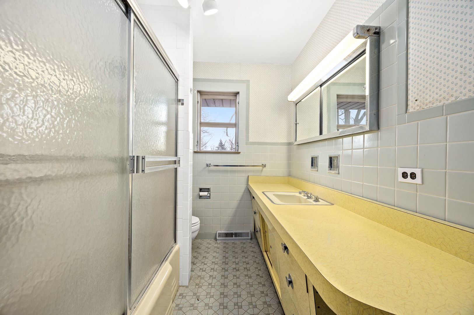 1927 Warrenville Road Lisle, IL 60532 - Photo 19 of 41 a bathroom with a granite countertop sink a mirror and a bathtub