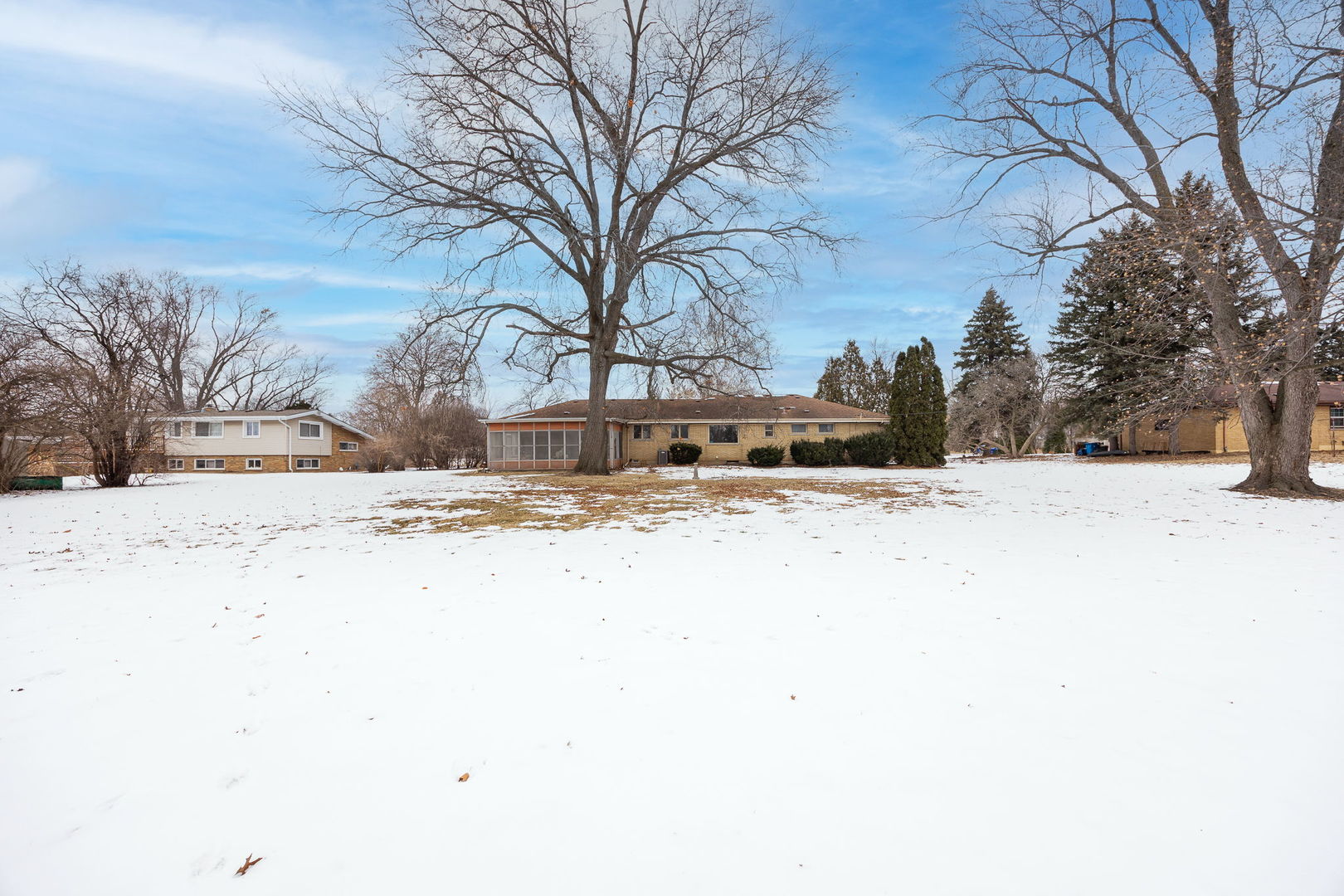 1927 Warrenville Road Lisle, IL 60532 - Photo 36 of 41 a large house with a snow on the side of a road