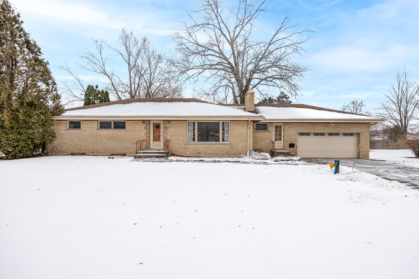 1927 Warrenville Road Lisle, IL 60532 - Photo 37 of 41 a front view of a house with a yard covered with snow