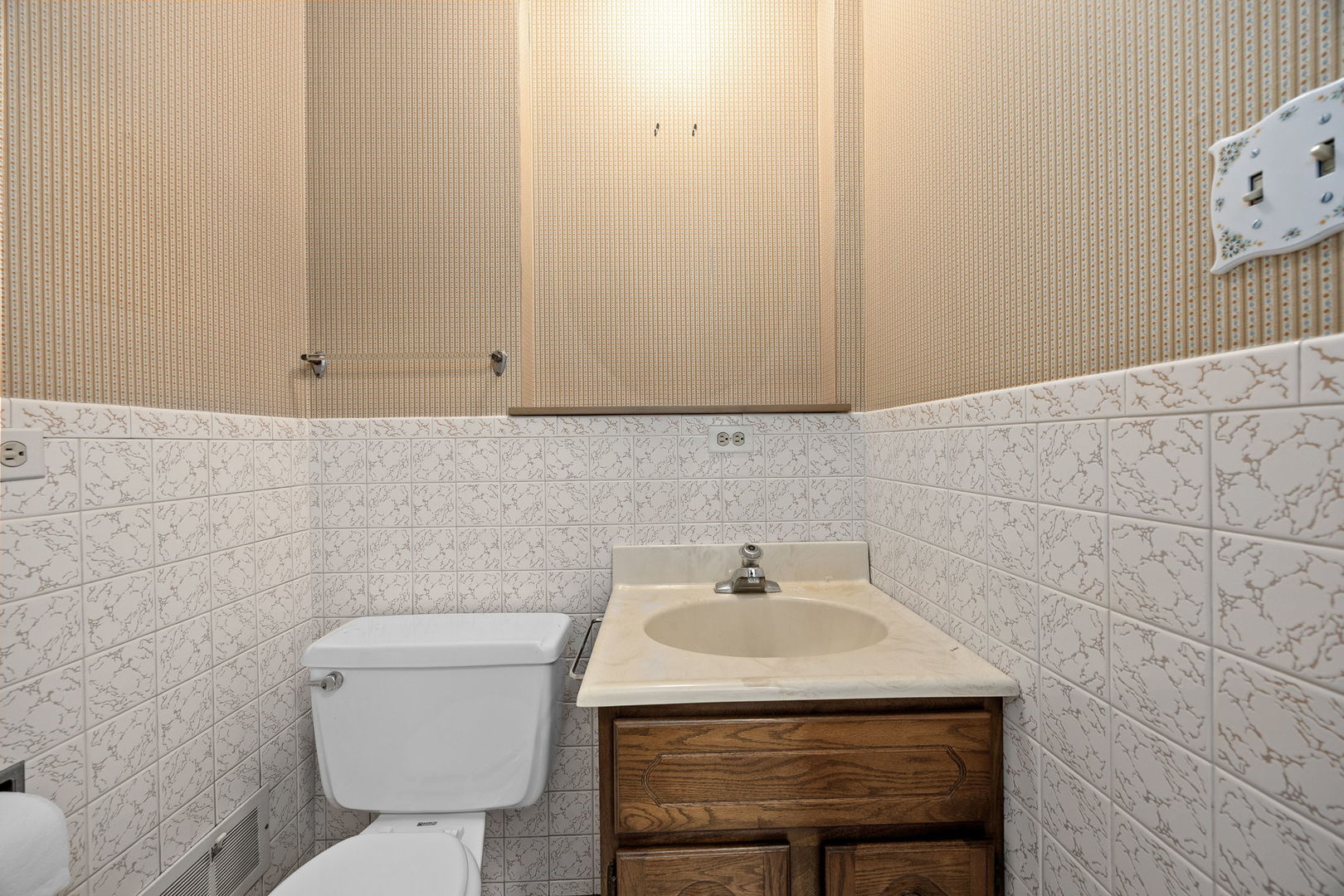 1927 Warrenville Road Lisle, IL 60532 - Photo 9 of 41 a bathroom with a sink a toilet and a mirror