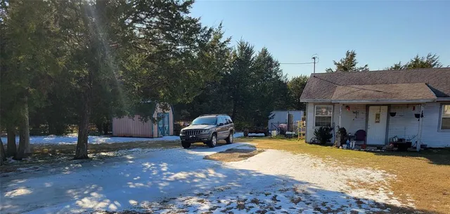 a front view of a house with a yard and sitting area