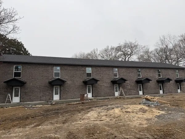 a view of a backyard with table and chairs
