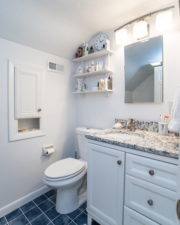 63 Cherry Lane Amherst, MA 01002 - Photo 32 of 36 a bathroom with a granite countertop toilet sink and mirror