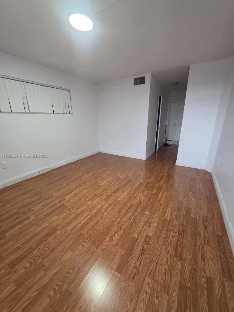 1710 Northeast 191st Street, Unit 3013 Miami, FL 33179 - Photo 16 of 23 wooden floor in a hall with an entryway