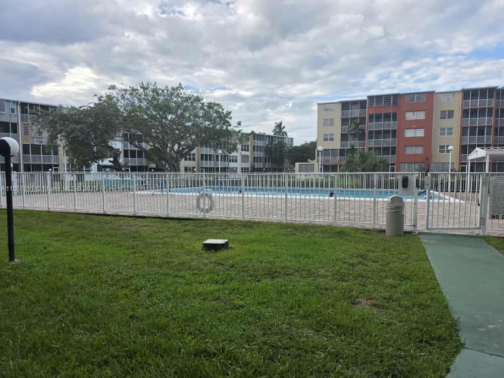 1710 Northeast 191st Street, Unit 3013 Miami, FL 33179 - Photo 21 of 23 a view of a garden with a slide