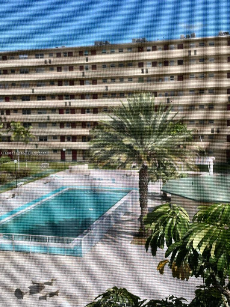 1710 Northeast 191st Street, Unit 3013 Miami, FL 33179 - Photo 4 of 23 a view of a tall building with a yard