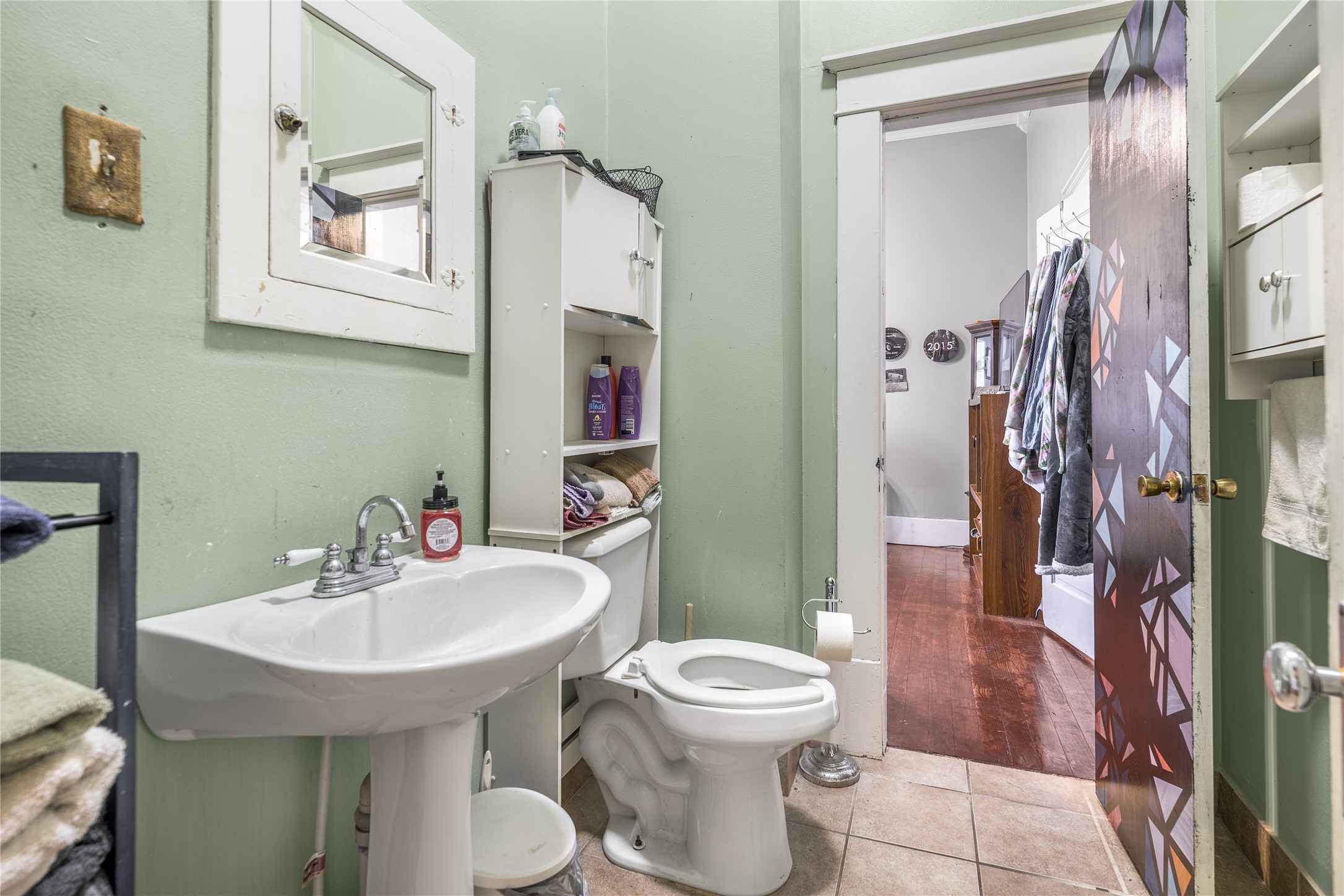 1000 North Park Street Brenham, TX 77833 - Photo 21 of 23 a bathroom with a toilet sink and mirror