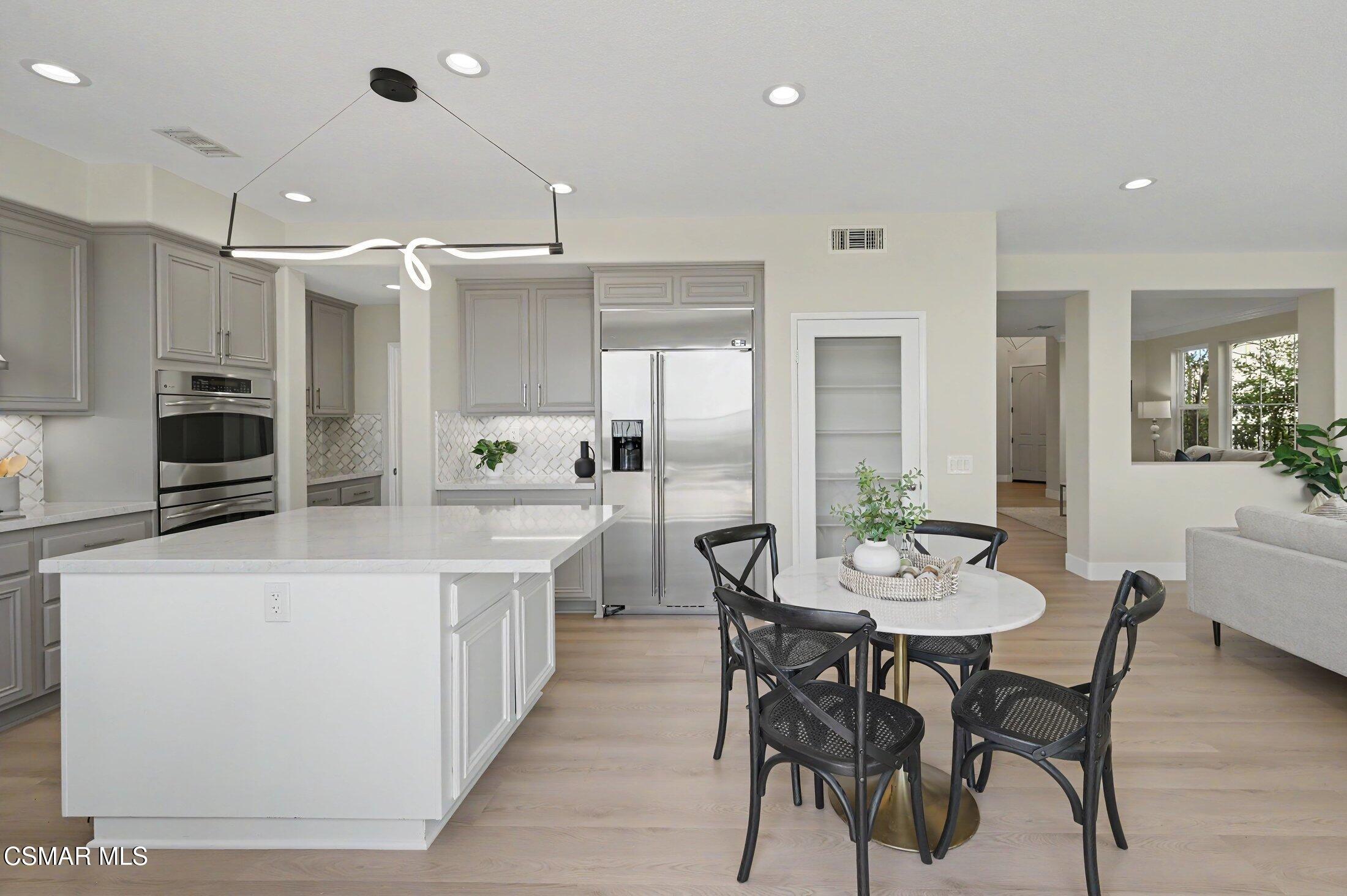 20800 Sardinia Way Porter Ranch, CA 91326 - Photo 12 of 57 a large kitchen with a table and chairs