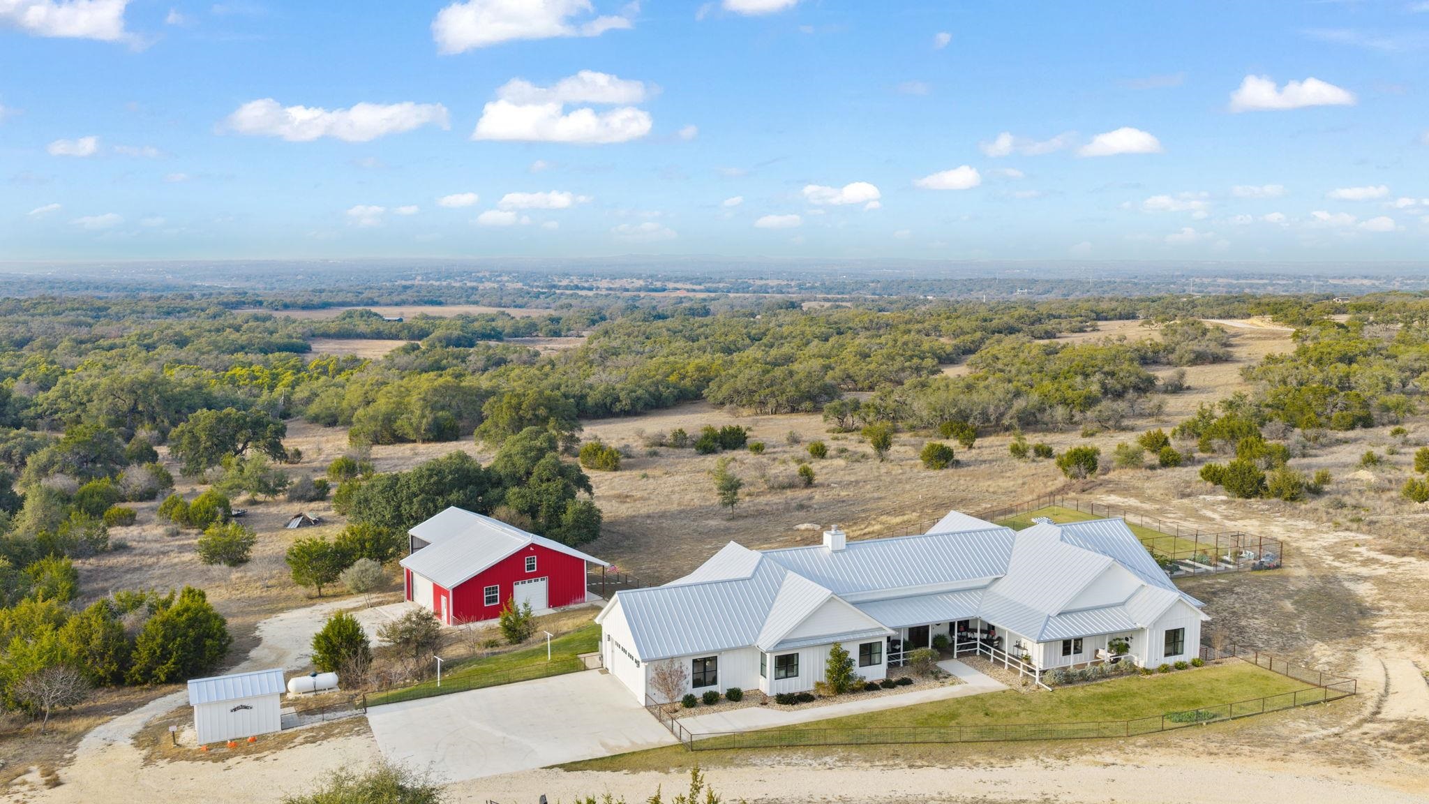 452 Southwick Ranch Road Johnson City, TX 78636 - Photo 42 of 44 an aerial view of residential houses with outdoor space and ocean view