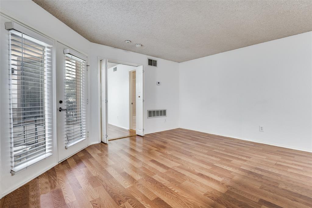 2311 Basil Drive, Unit C304 Arlington, TX 76006 - Photo 6 of 12 a view of an empty room with wooden floor and a window