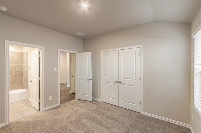 an empty room with closet area