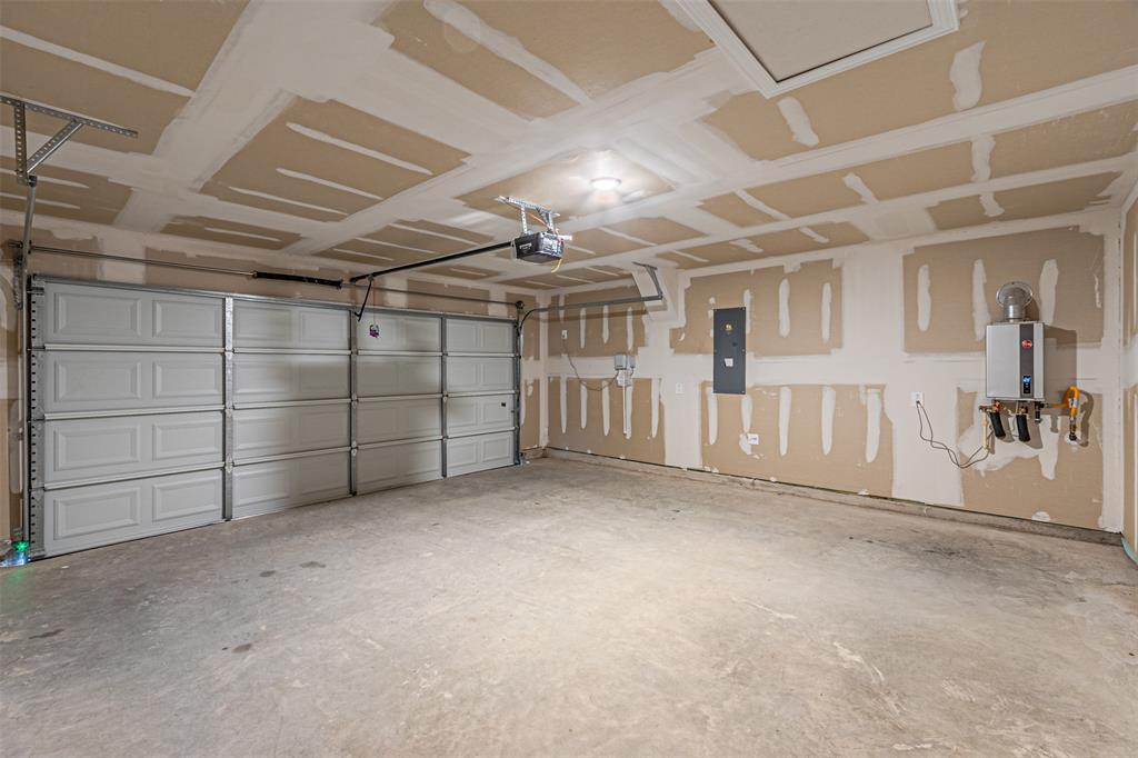 780 Moonlight Place Lavon, TX 75166 - Photo 14 of 35 Garage with electric panel and a garage door opener