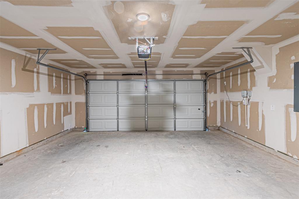 780 Moonlight Place Lavon, TX 75166 - Photo 15 of 35 Garage featuring a garage door opener