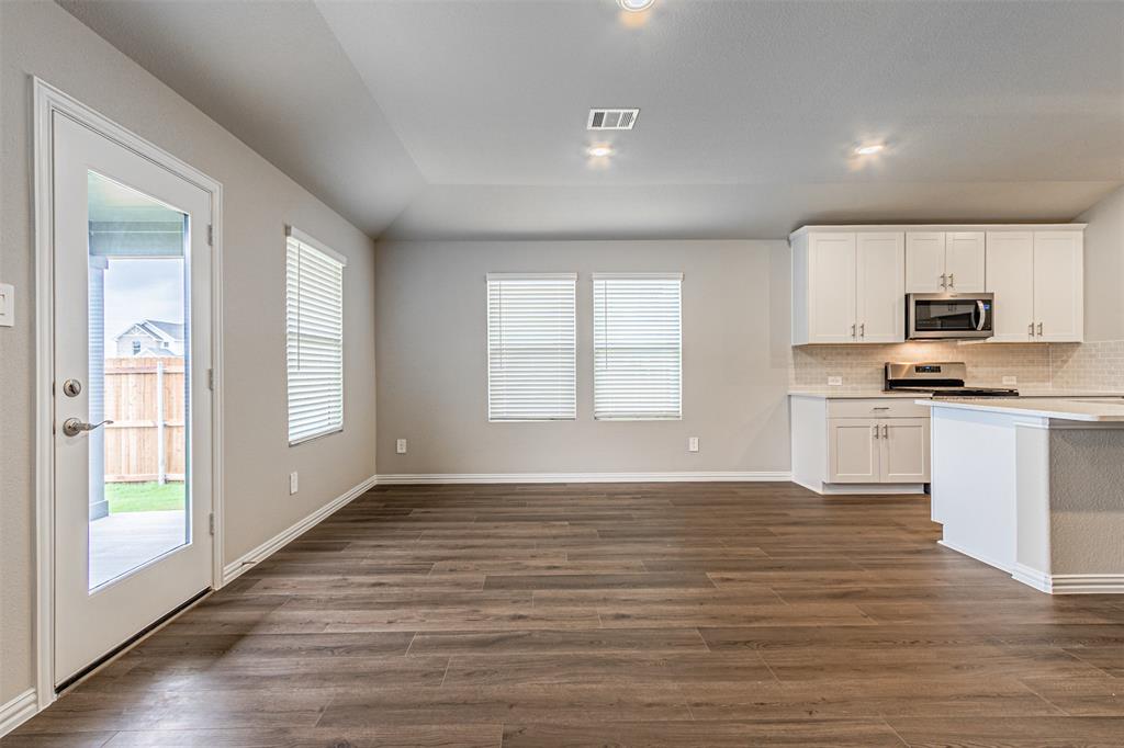 780 Moonlight Place Lavon, TX 75166 - Photo 18 of 35 Kitchen with white cabinetry, backsplash, dark wood-style flooring, stainless steel appliances, and recessed lighting
