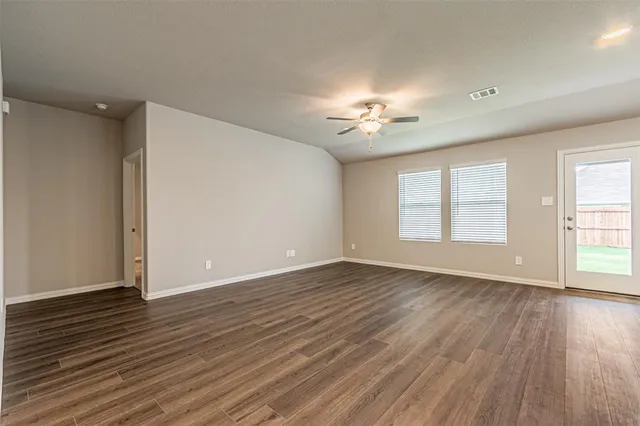 a kitchen with a refrigerator and white cabinets