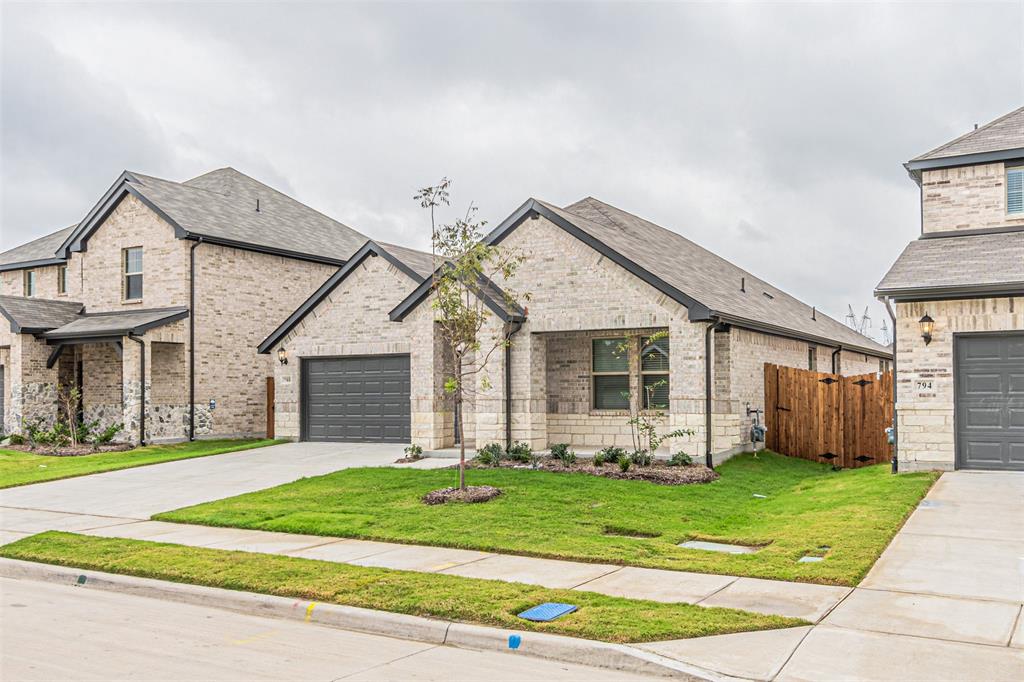 780 Moonlight Place Lavon, TX 75166 - Photo 2 of 35 View of front of house with brick siding, roof with shingles, and concrete driveway