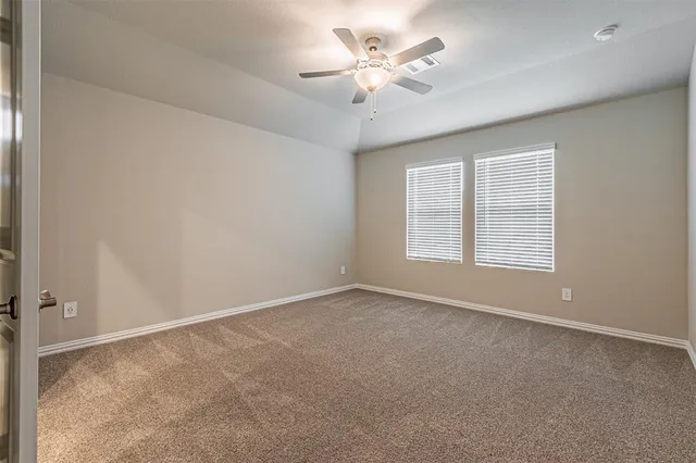 a view of a livingroom with a ceiling fan window and wooden floor
