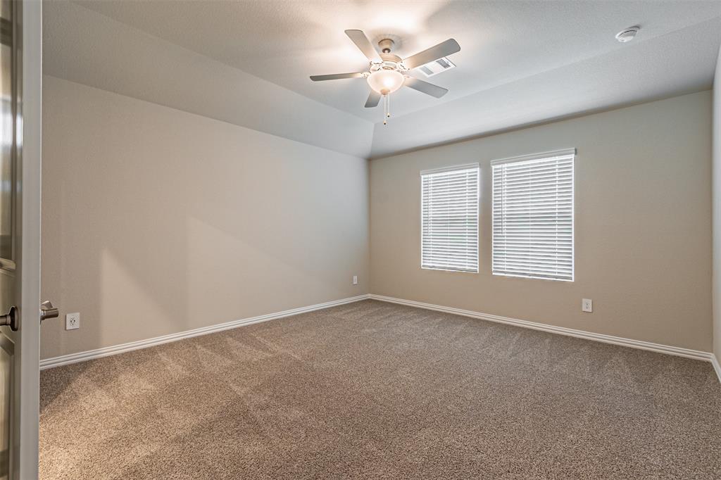 780 Moonlight Place Lavon, TX 75166 - Photo 21 of 35 Empty room featuring light carpet, ceiling fan, and lofted ceiling