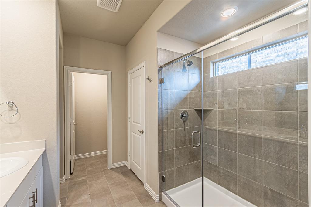 780 Moonlight Place Lavon, TX 75166 - Photo 25 of 35 Full bathroom featuring vanity, a stall shower, and light tile patterned floors