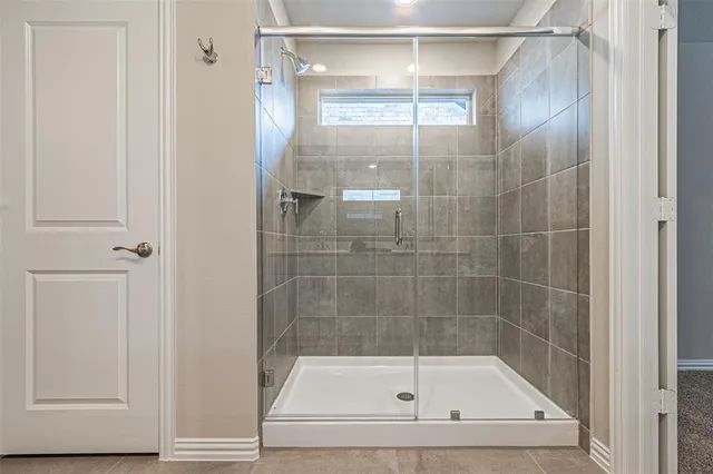 a spacious bathroom with a double vanity sink mirror and shower