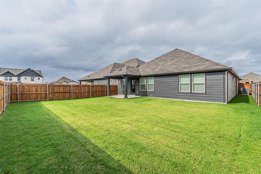 780 Moonlight Place Lavon, TX 75166 - Photo 33 of 35 Rear view of property featuring a patio, roof with shingles, and a fenced backyard