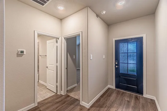 a view of hallway with wooden floor