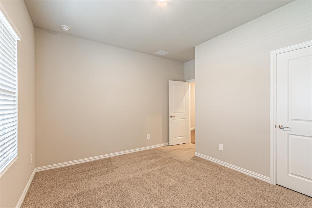 780 Moonlight Place Lavon, TX 75166 - Photo 7 of 35 Unfurnished bedroom featuring carpet and baseboards