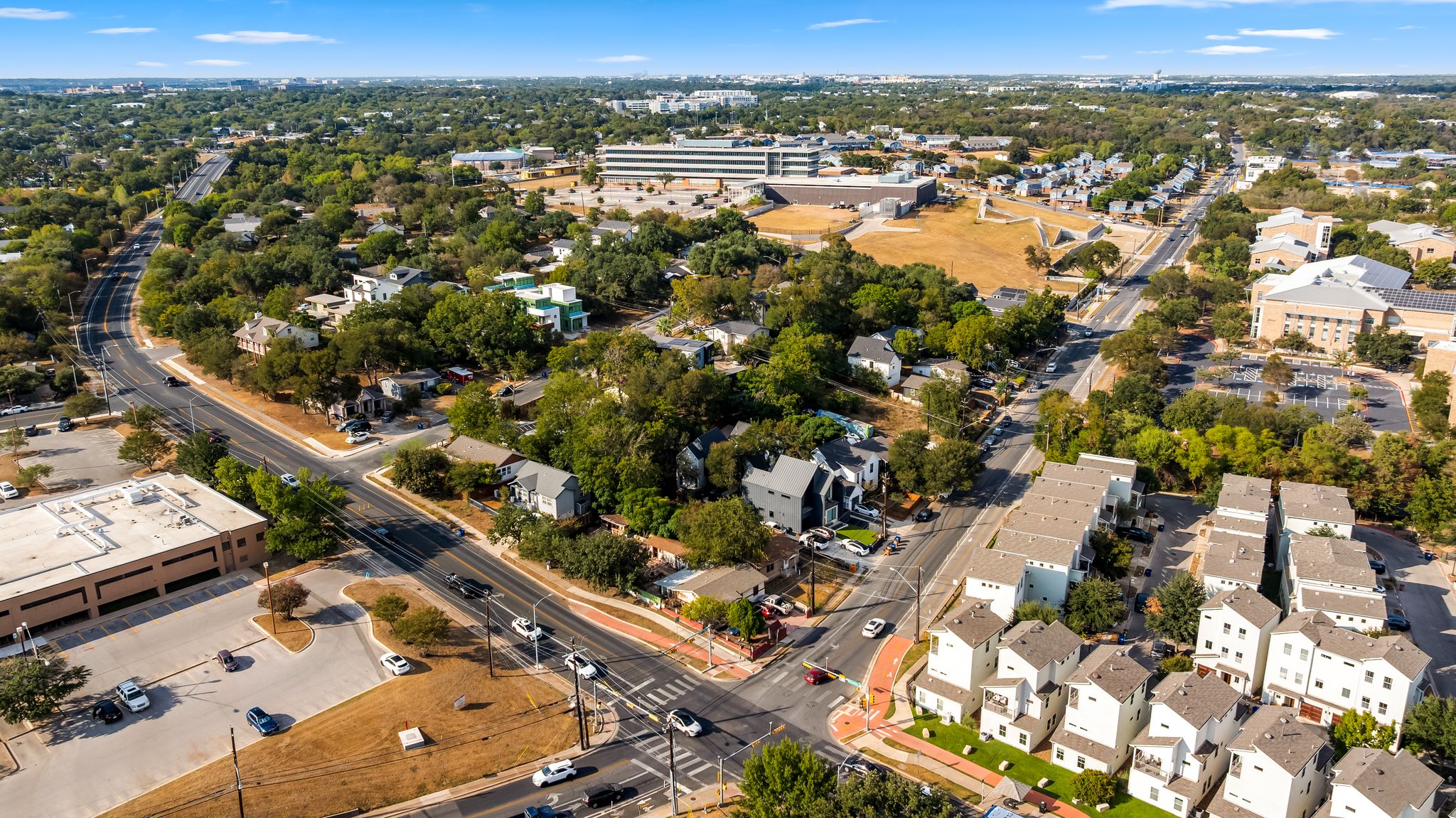 2900 Webberville Road Austin, TX 78702 - Photo 10 of 22 An aerial perspective reveals a vibrant neighborhood nestled among mature trees and winding streets.