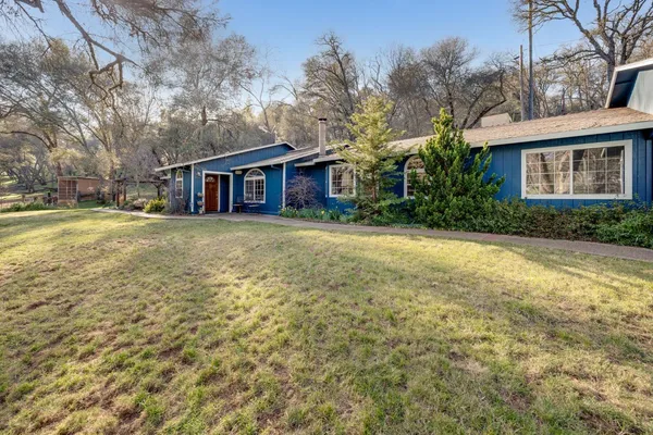 a view of a house with a yard and garage