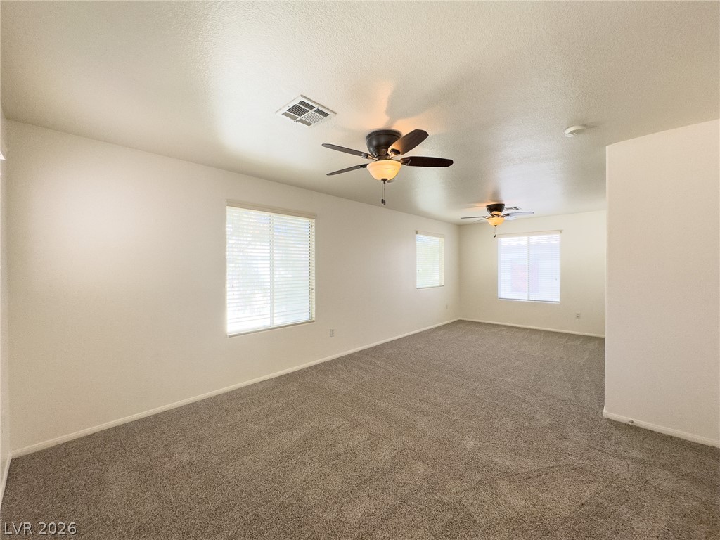 9456 Grandview Spring Avenue Las Vegas, NV 89166 - Photo 22 of 49 A spacious room offers comfortable carpeting and multiple windows for abundant natural light.