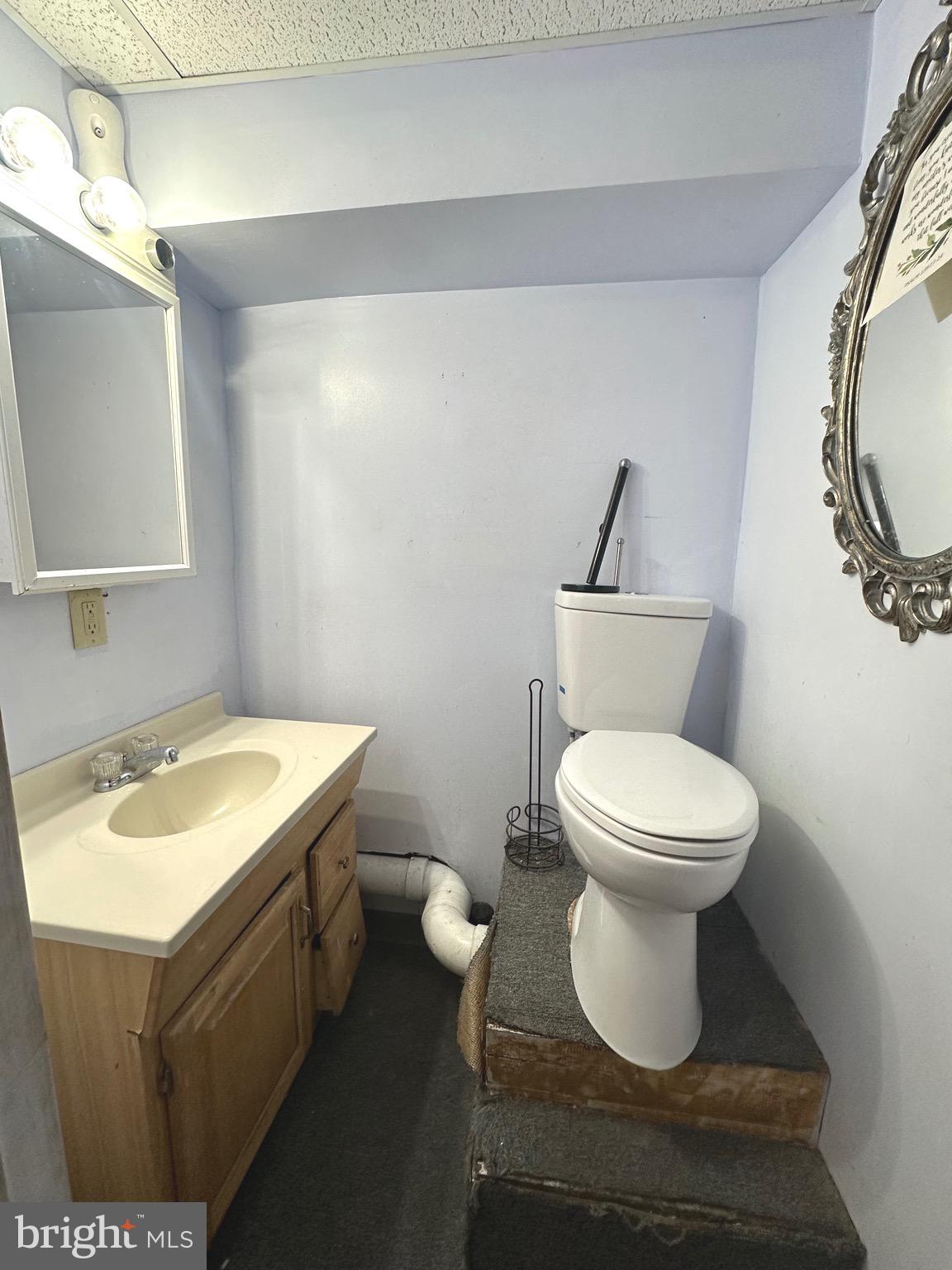 5332 Master Street Philadelphia, PA 19131 - Photo 13 of 17 a bathroom with a toilet sink and mirror