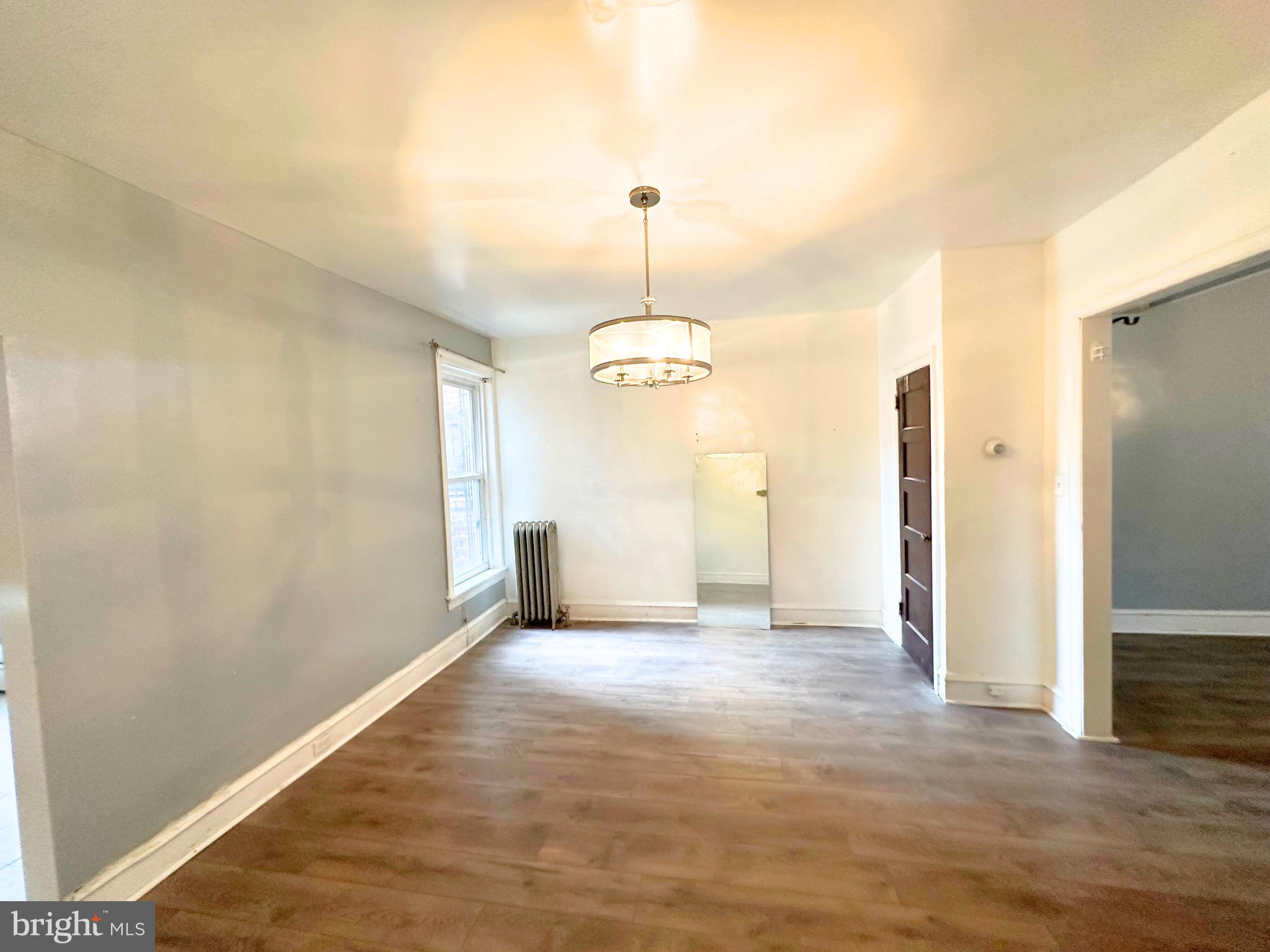 5332 Master Street Philadelphia, PA 19131 - Photo 3 of 17 an empty room with wooden floor and ceiling fan