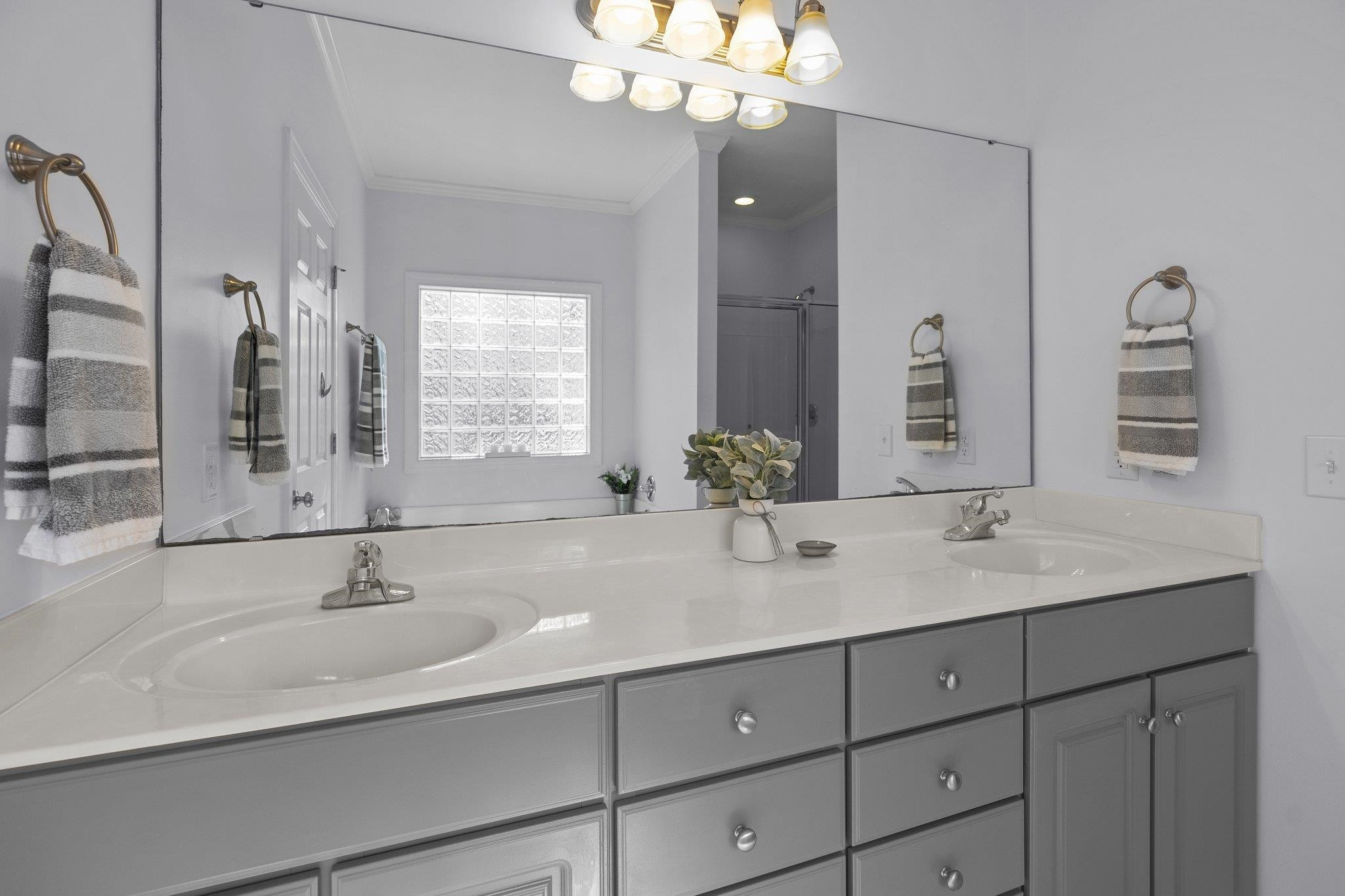 104 Shadow Lane Oxford, NC 27565 - Photo 16 of 38 a bathroom with double vanity sinks a vanity a lamp and a mirror