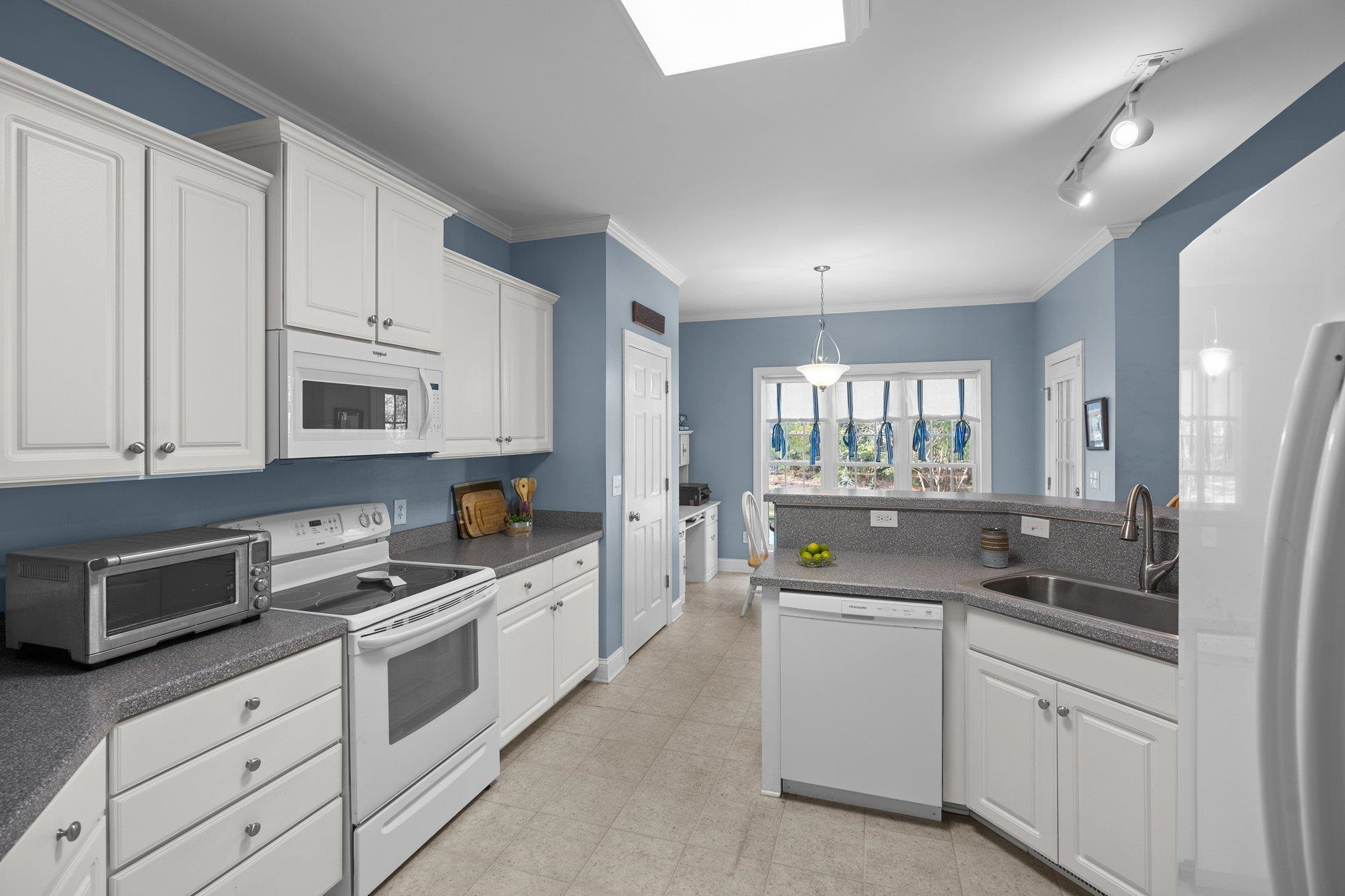 104 Shadow Lane Oxford, NC 27565 - Photo 8 of 38 a kitchen with granite countertop white cabinets and white appliances