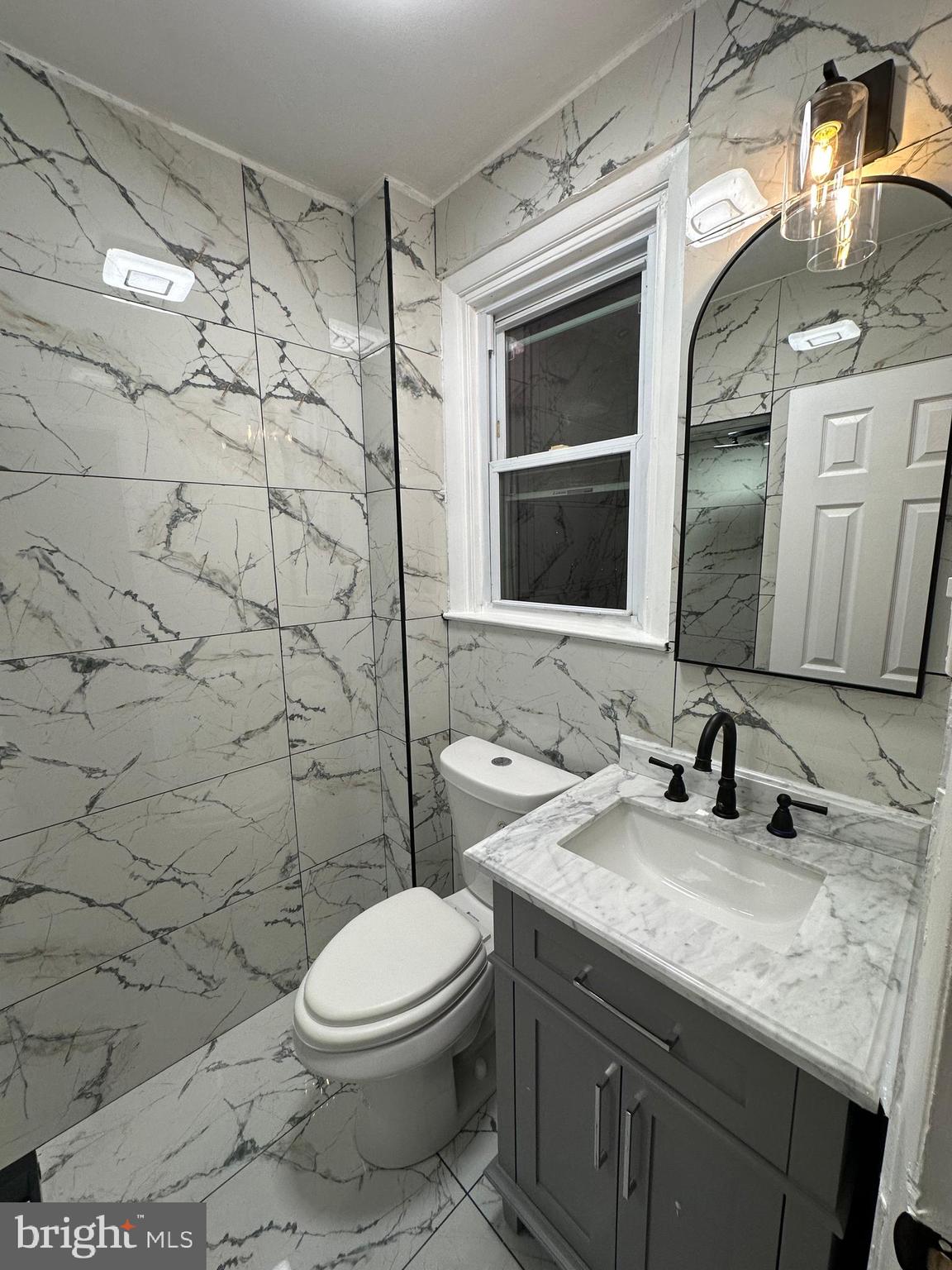 8540 Castor Avenue Philadelphia, PA 19152 - Photo 18 of 23 a bathroom with a granite countertop sink a toilet and shower