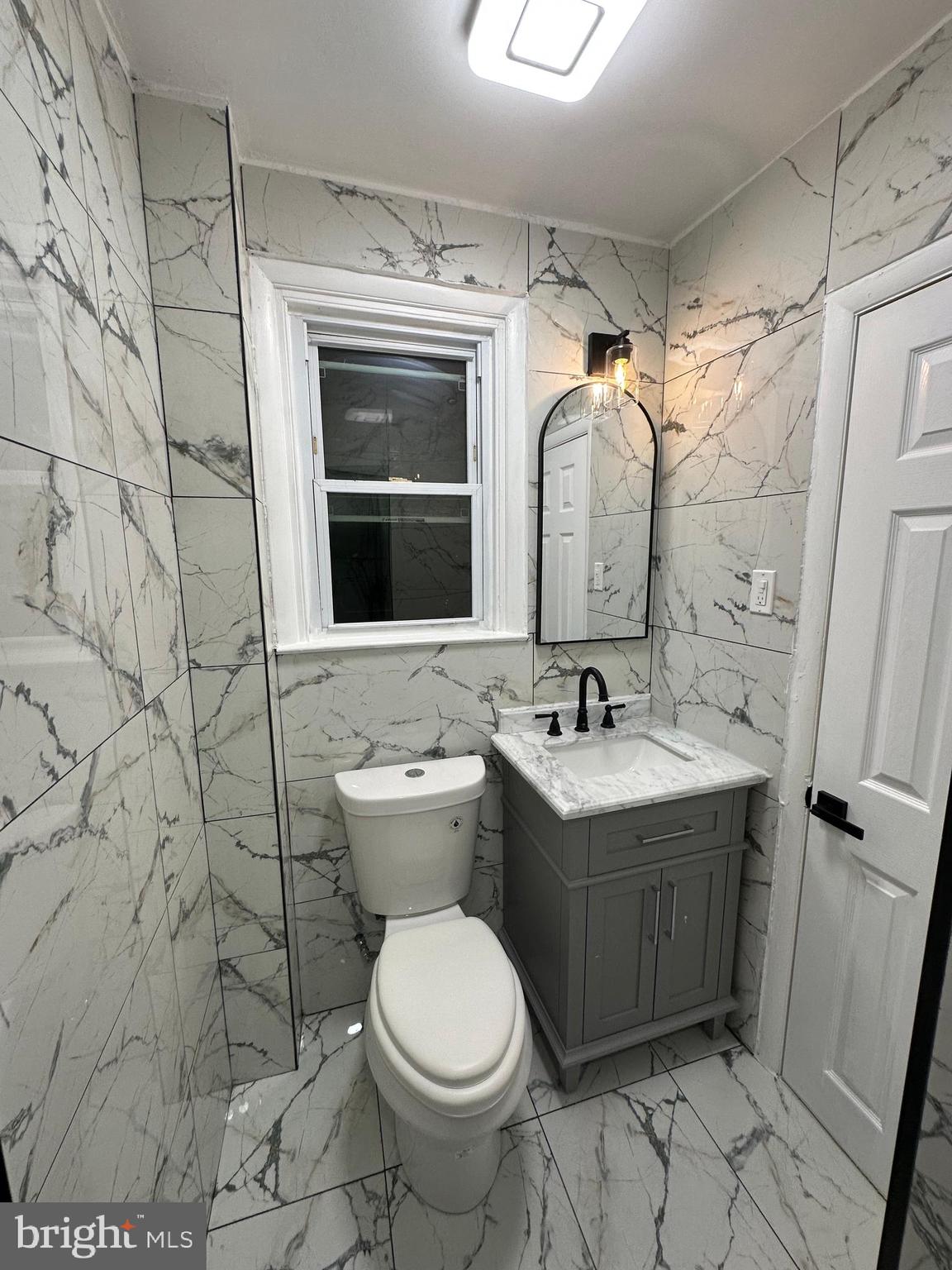 8540 Castor Avenue Philadelphia, PA 19152 - Photo 19 of 23 a bathroom with a sink and mirror with toilet