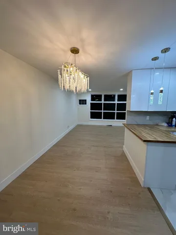 a view of kitchen with refrigerator and window