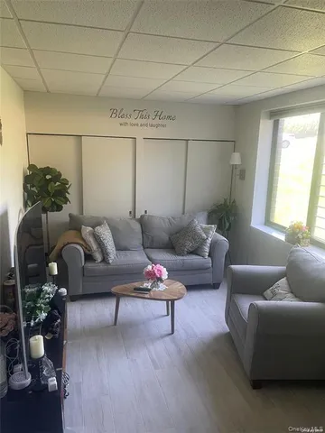 a living room with furniture and flowers