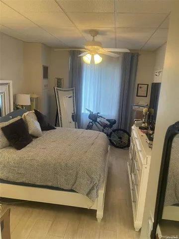 a bedroom with a bed and a mirror