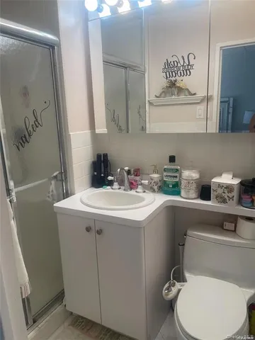 a bathroom with a sink toilet and mirror
