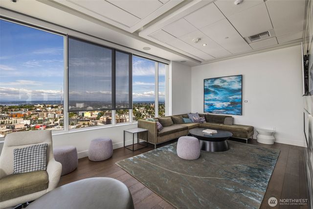 a living room with furniture a rug and a chandelier