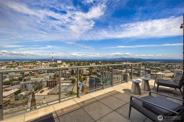 a view of a patio with a dining table and chairs with wooden floor