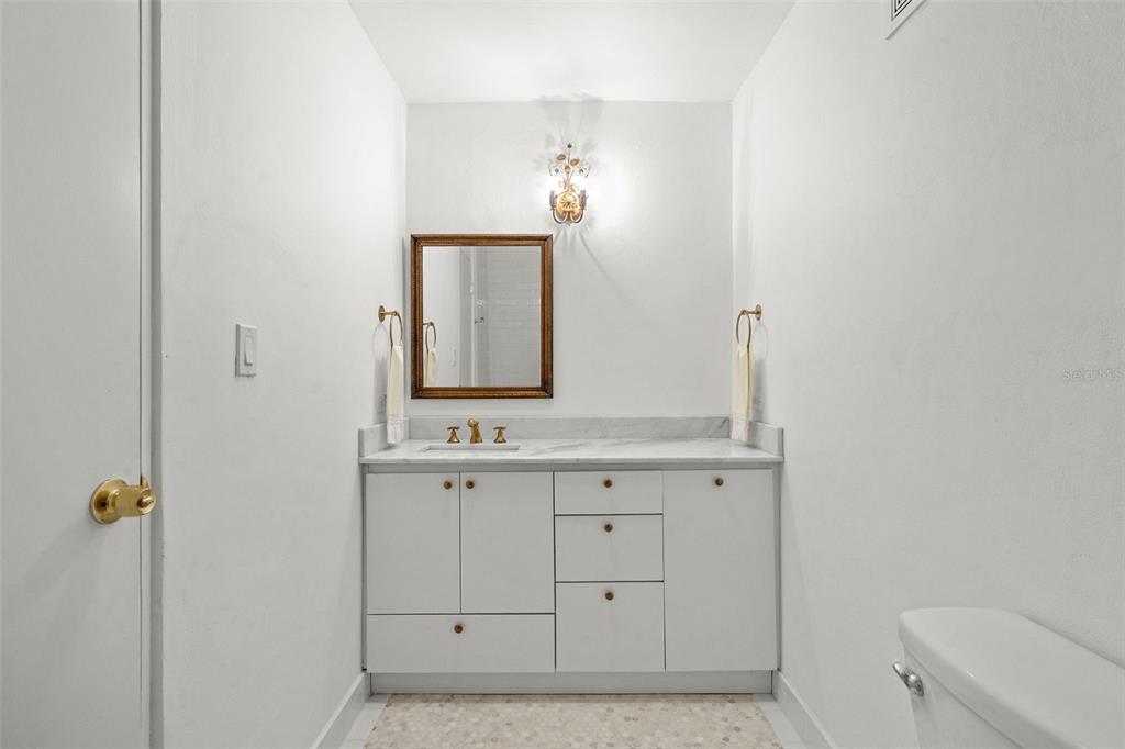 7 Barcelona Street Humacao, PR 00791 - Photo 11 of 16 a bathroom with a sink a toilet and mirror