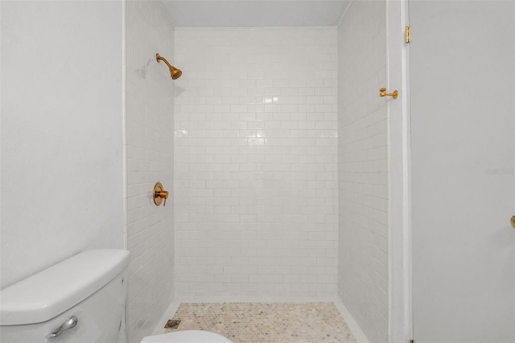 7 Barcelona Street Humacao, PR 00791 - Photo 12 of 16 a bathroom with a shower and a toilet