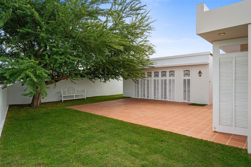 7 Barcelona Street Humacao, PR 00791 - Photo 13 of 16 a backyard of a house with lots of green space